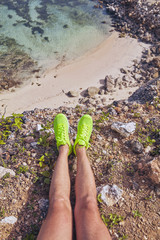 Wall Mural - Sportsman stretching on a tropical exotic cliff near the ocean.