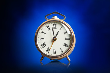 Wall Mural - Alarm clock on blue background.