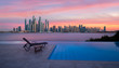Skyline of Dubai Marina at a beautiful sunset with an infinity pool in front