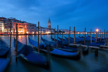 Wall Mural - The famous Gondolas are parking on the Canal Grande in the evening in Venice, Italy