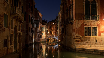 Wall Mural - Small canal in Venice by night with a  beautiful old bridge