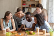 © fizkes - Happy black guy showing funny videos on smartphone.