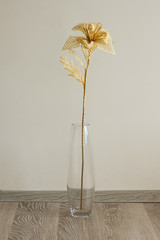 Bouquet of flowers made of straw in a glass vase