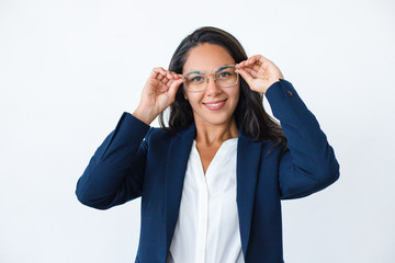 Wall Mural - Happy businesswoman wearing eyeglasses. Portrait of attractive cheerful young woman in formal wear and spectacles smiling at camera. Business concept