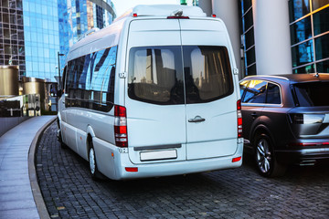 Wall Mural - white mini bus moves down the street