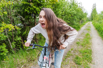 Wall Mural - Young woman riding bicycle in summer city park outdoors. Active people. Hipster girl relax and rider bike. Cycling to work at summer day. Bicycle and ecology lifestyle concept