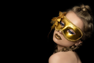 Wall Mural - Young beautiful woman wearing golden party mask