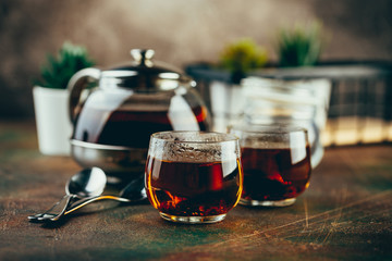 Wall Mural - Transparent glass teapot black tea and glass cups