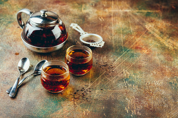 Wall Mural - Transparent glass teapot black tea and glass cups