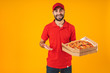 Photo of happy joyful man in red uniform smiling and holding pizza box