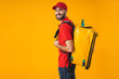 Photo of attractive delivery man in red uniform carrying backpack with takeaway food