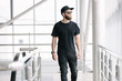 © 4Max - Hipster handsome male model with beard wearing black blank t-shirt with space for your logo or design in casual urban style