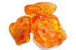 Amber. Three pieces of transparent yellow amber on a white background. Sun stone. Natural mineral fossilized ancient resin. Material for jewelry products. Yellow colored stone