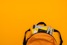 Back To School Concept. Backpack With School Supplies On Yellow Background. Top View. Copy Space. Flat Lay