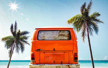 A Red Orange Vintage Van In The Ocean And Sunny Beach View. Summer Time And Fun On The Beach.