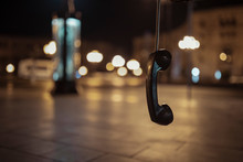 The Public Pay Phone. Hanging Public Telephone At Night , Ear Phone,  Pay Phone. Hanging Phone. Feelings - Separation, Emptiness, Loneliness, Resentment.