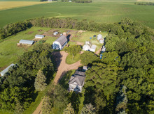 Aerial View Of Quaint Farmhouse And Barns On A Farm In South Dakota.