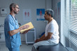 © Wavebreak Media - Male surgeon interacting with patient in hospital