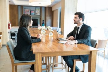 Wall Mural - Businesswoman Explaining Business Model To Entrepreneur In Hotel