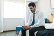 © AntonioDiaz - Professional Texting On Mobile Phone In Hotel Room