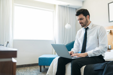 Wall Mural - Serious Executive Working On Laptop In Hotel Room