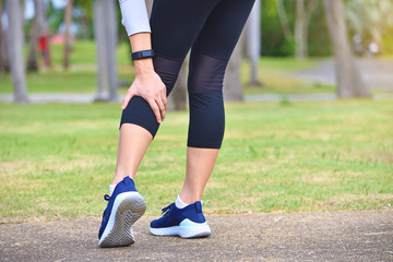 Young woman feel pain on her leg while exercising