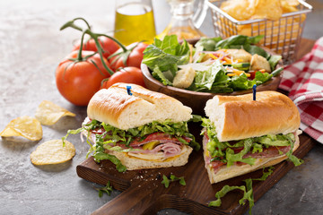 Wall Mural - Italian meat sandwich with salad and chips for lunch