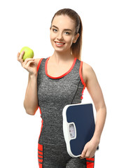 Poster - Young woman with apple and scales on white background. Weight loss concept