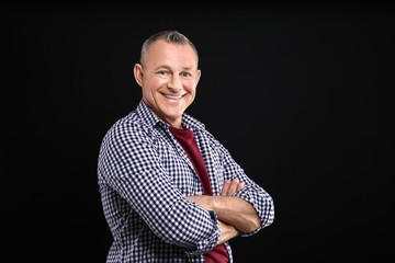 Wall Mural - Portrait of handsome middle-aged man on dark background