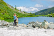 © Ermolaev Alexandr - Family traveling. Mother hugging her little son and looks at the Karakol lake in the Altai Mountains. Empty space for text