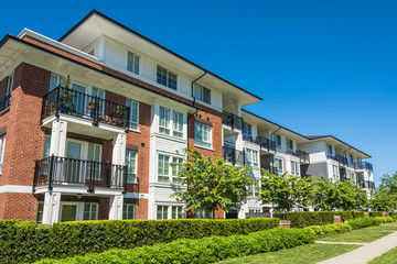 Luxury apartment building with green lawn in front