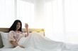 © Paisan - Portait of smiling lady wake up welcome morning light on the bed
