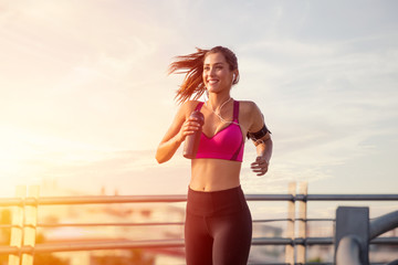 Young woman with fit body running. Female model in sportswear exercising outdoors.Woman Doing Workout Exercises On Street.