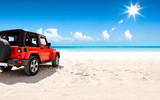 A red jeep on sandy beach and beuatiful blue sunny sky view in summer time.