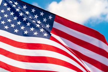 Wall Mural - American flag waving in the wind against blue sky