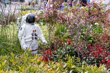 Alien landscape with American astronauts landing on the Moon theme community garden in the middle of town, Olhdam, UK.