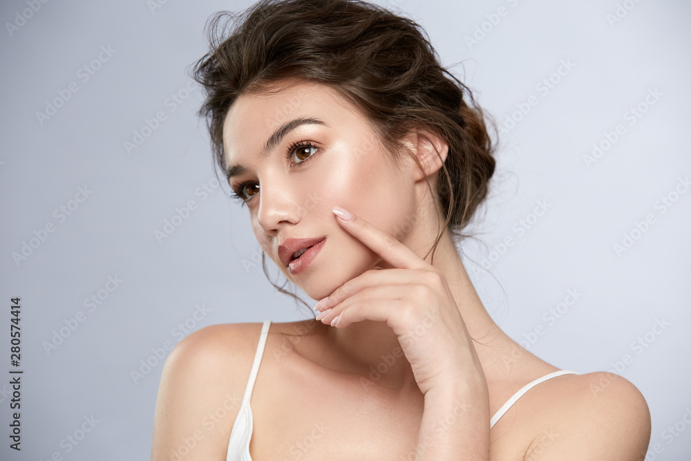 sexy lady with shiny highlighter looking to the side and touching face - obrazy, fototapety, plakaty 