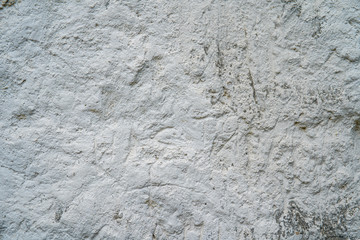 White natural chalk rock wall. Grunge gray and white background texture, close up