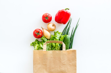 Wall Mural - Healthy food with fresh vegetables in paper bag on white background top view