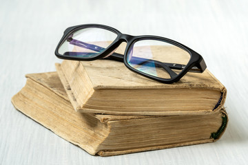 Eyeglasses on stacked books