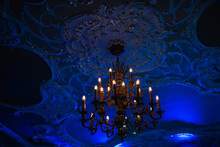 Interior Details At A Party. Chandelier Under The Ceiling With Stucco
