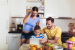 © Mediteraneo - Pregnant woman and her family breakfasting in the kitchen