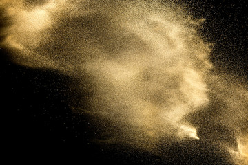 Wall Mural - Sand explosion isolated on black background. Freeze motion of sandy dust splash.