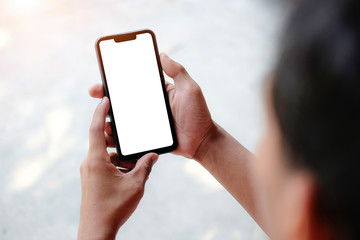 Mock up smartphone of hand holding black mobile phone with blank white screen