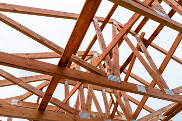 Wall Mural - Roof trusses not covered with ceramic tile on a detached house under construction, visible roof elements, battens, counter battens, rafters.