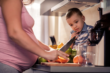 Wall Mural - Mother and child making fresh orange juice