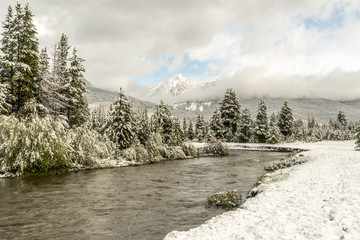 An alpine river soon after a summer snow storm with fresh snow on the grass and cloudy sky 2, Colorado River, Colorado