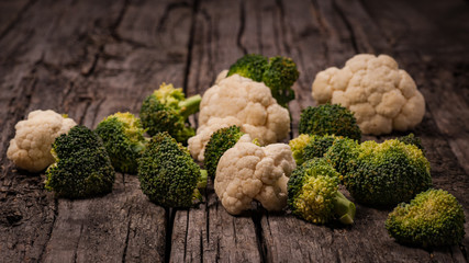 Broccoli and cauliflower on wooden background. Rustic
