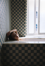 Young Woman Lying In Bathtub
