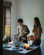 © Duet Postscriptum/Stocksy - The girls serves a Christmas table.
